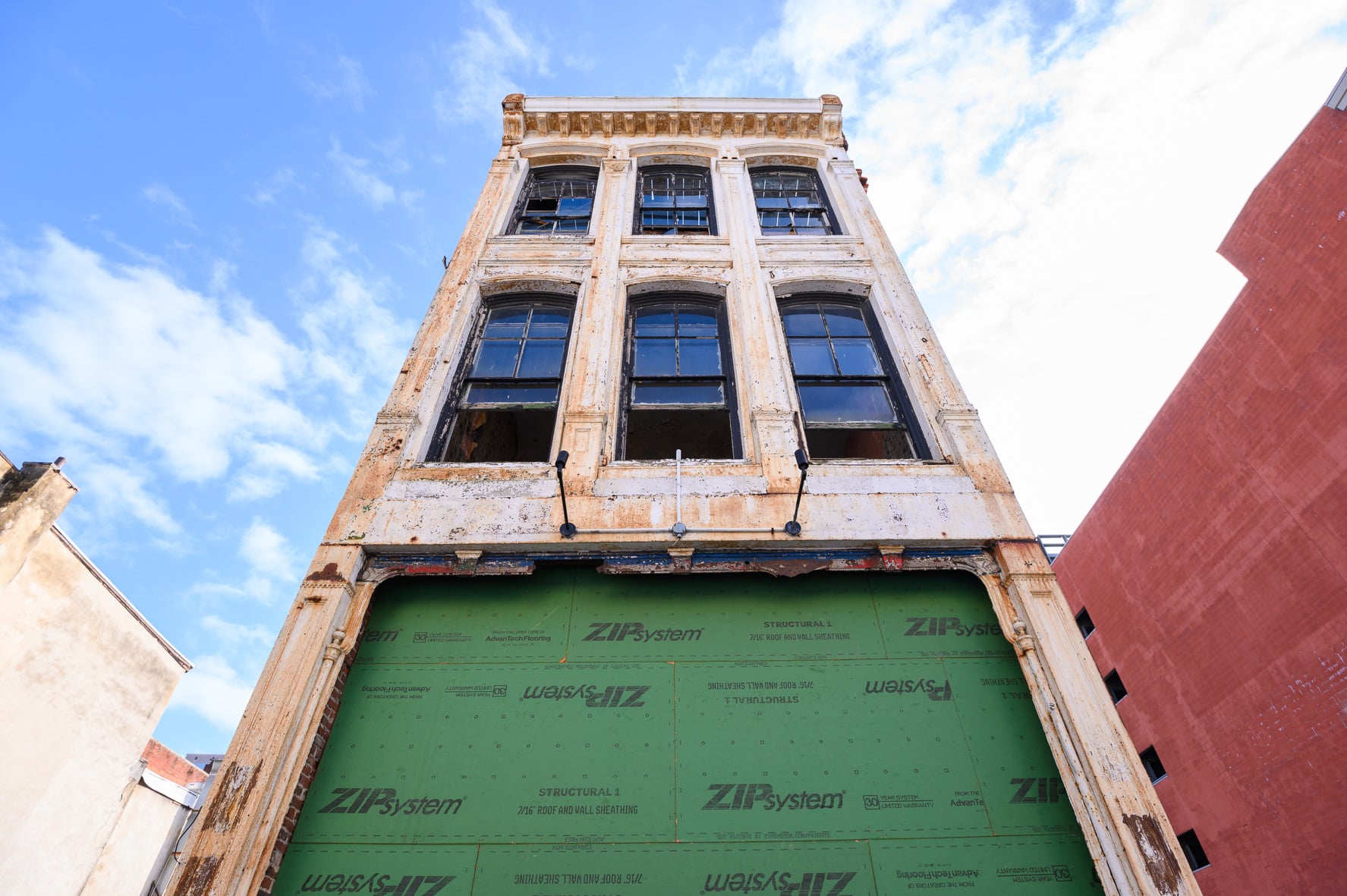 Historic building in Wilmington, DE with weathered exterior and tall windows on a sunny day