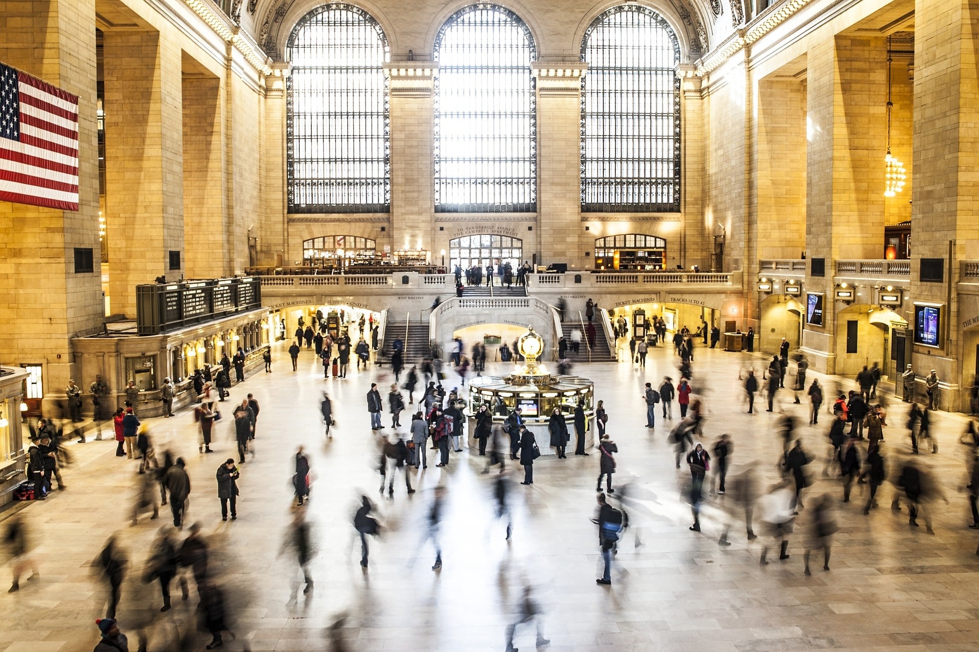 People moving around inside the train station.